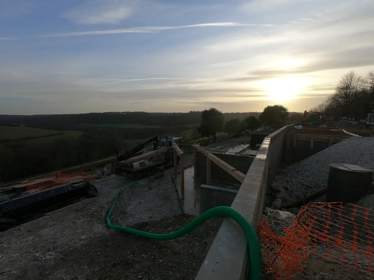 Construction site at sunset with site duct and netting