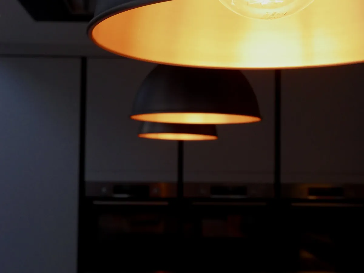 Dome pendant lights glowing over a kitchen island