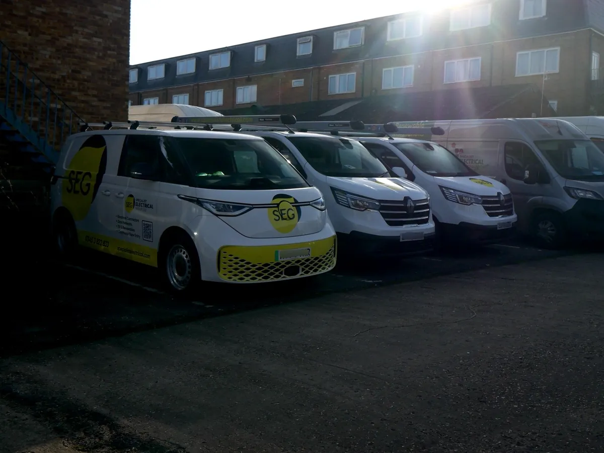 SEG vans parked in a row below a block of flats