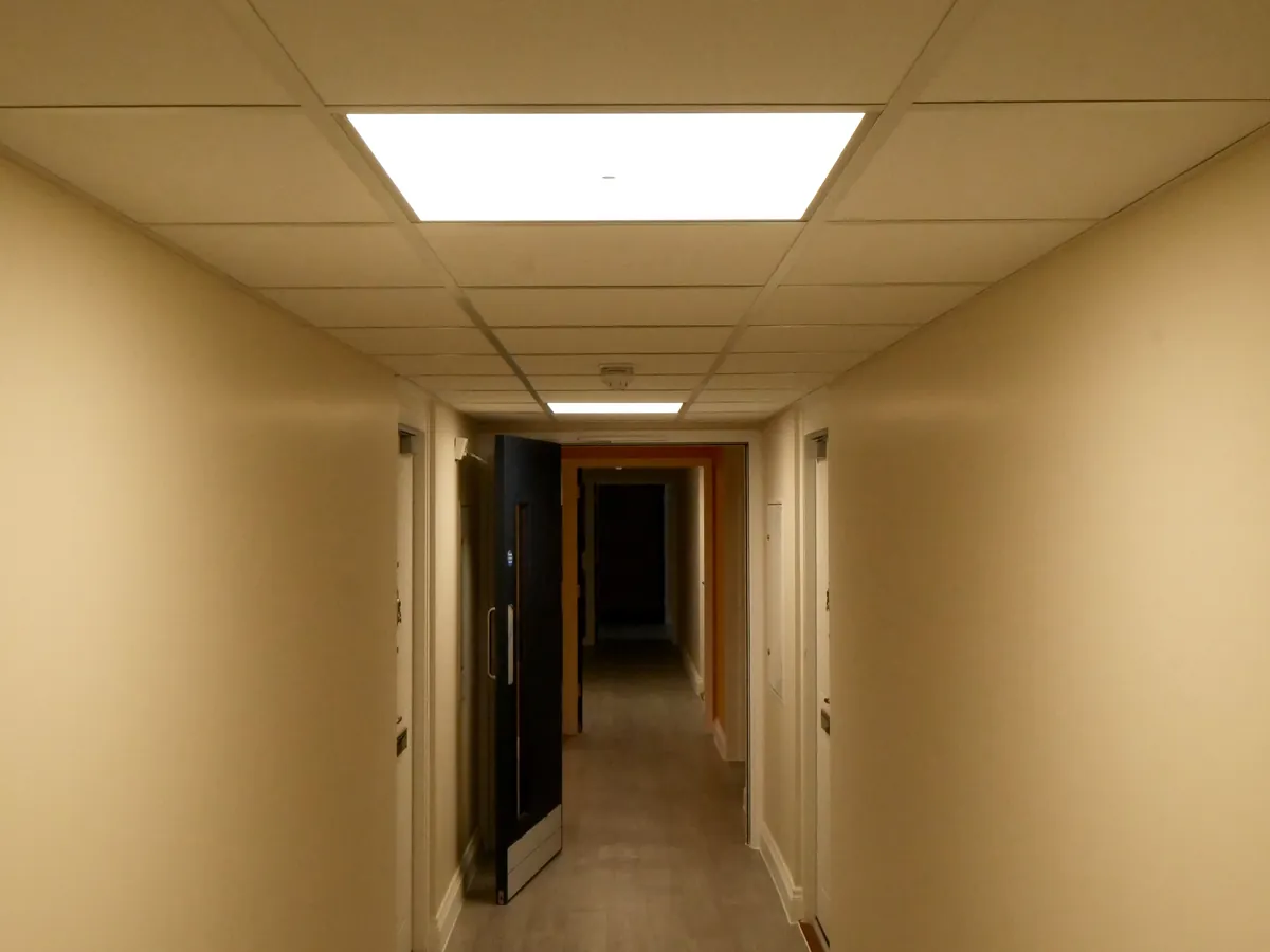 Finished residential corridor with LED panels and a smoke detector