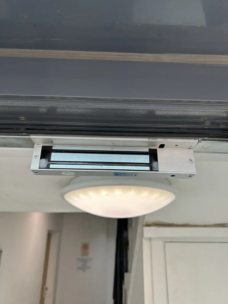 Replacement maglock on a communal entrance door in a block of flats