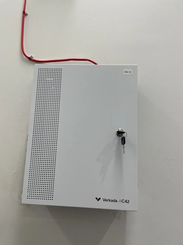Access control door controller mounted on an office wall