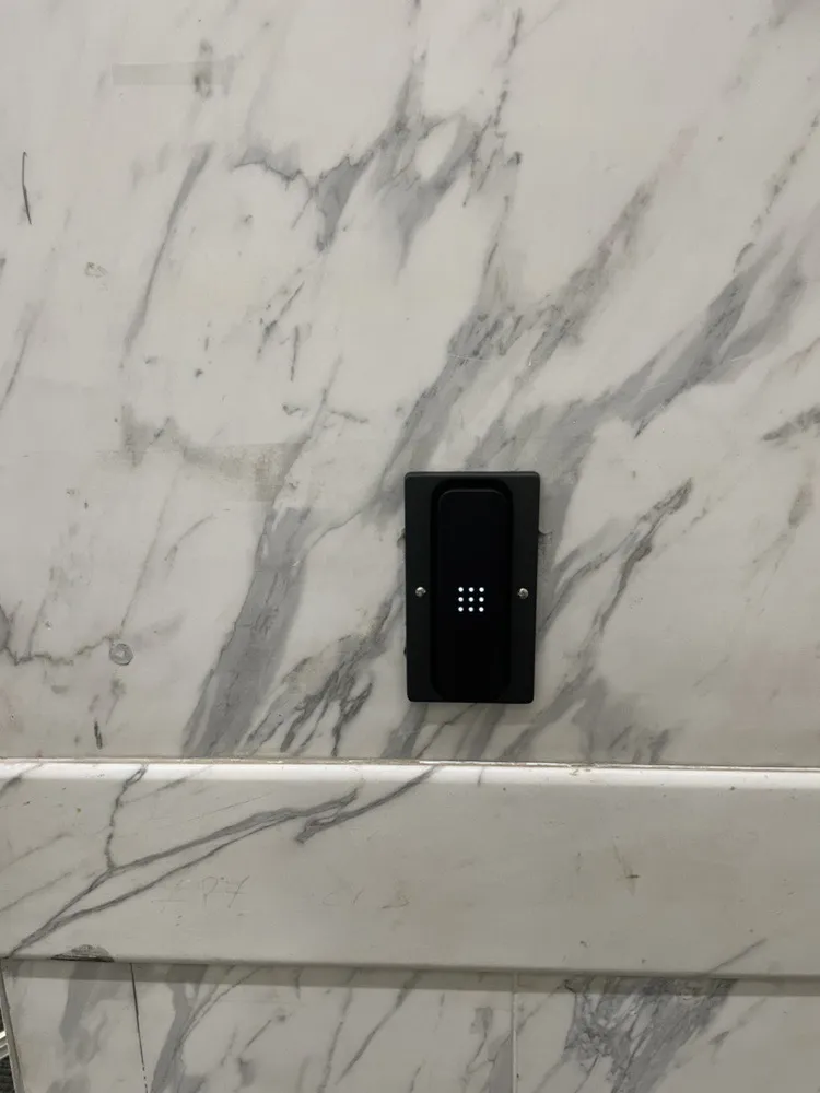 Access control card reader on a marble wall in an office entrance