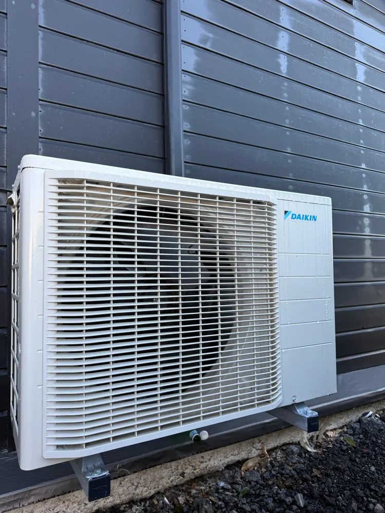 Daikin air conditioning outdoor unit on galvanised ground brackets in Chiswell Green, St Albans