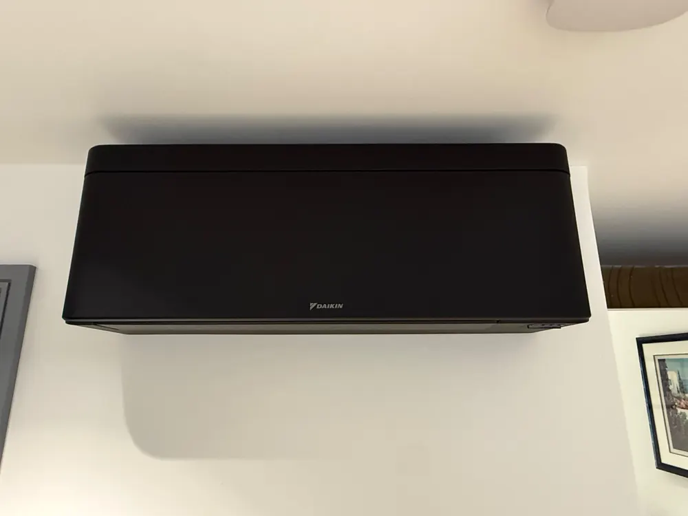 Matt-black Daikin air conditioning wall unit in a home in Park Street, St Albans