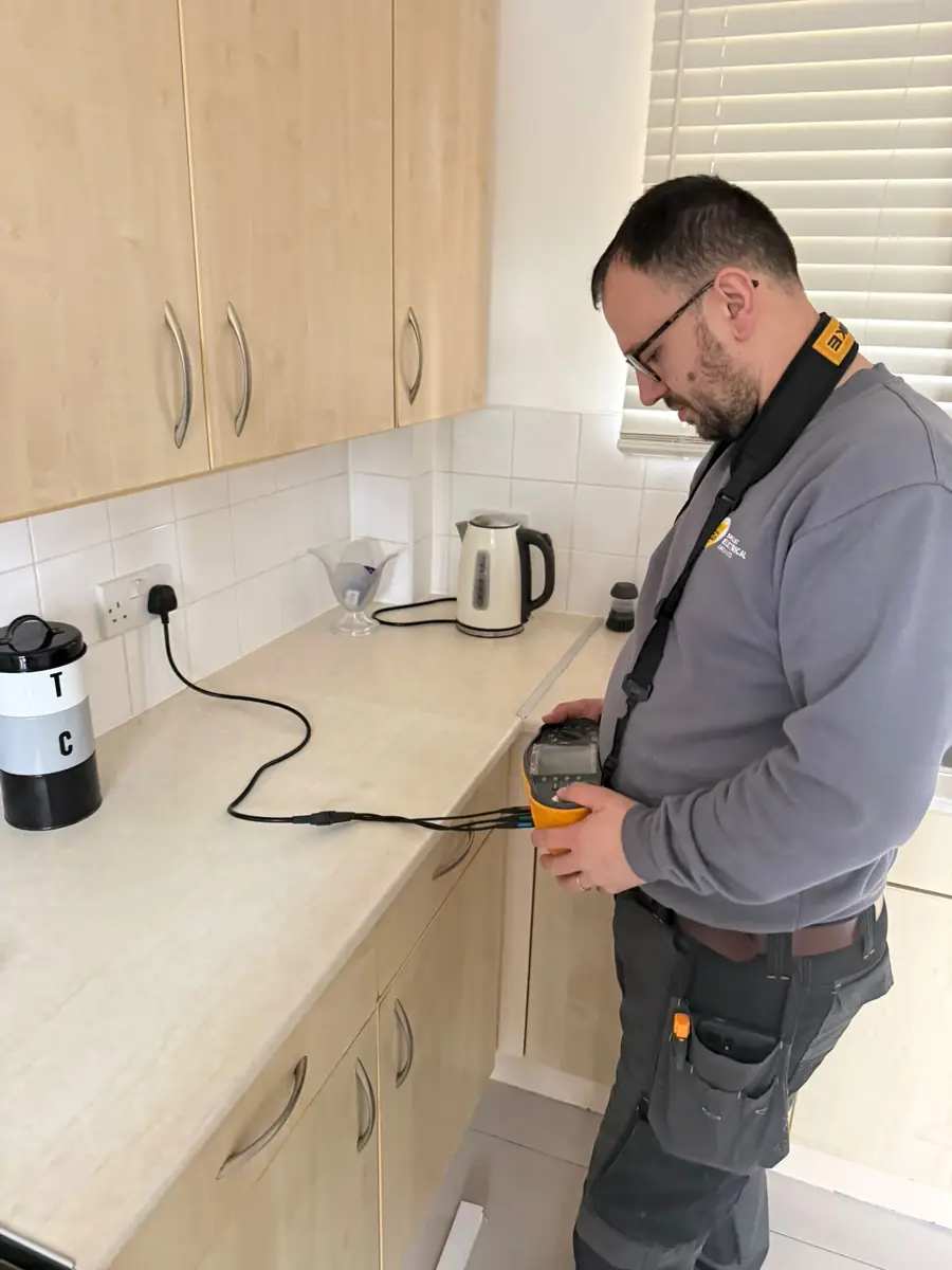 SEG engineer testing a kitchen socket circuit with a multifunction tester