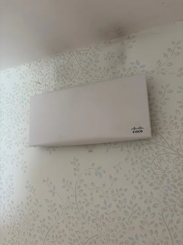 Wall-mounted Wi-Fi access point in a hotel suite