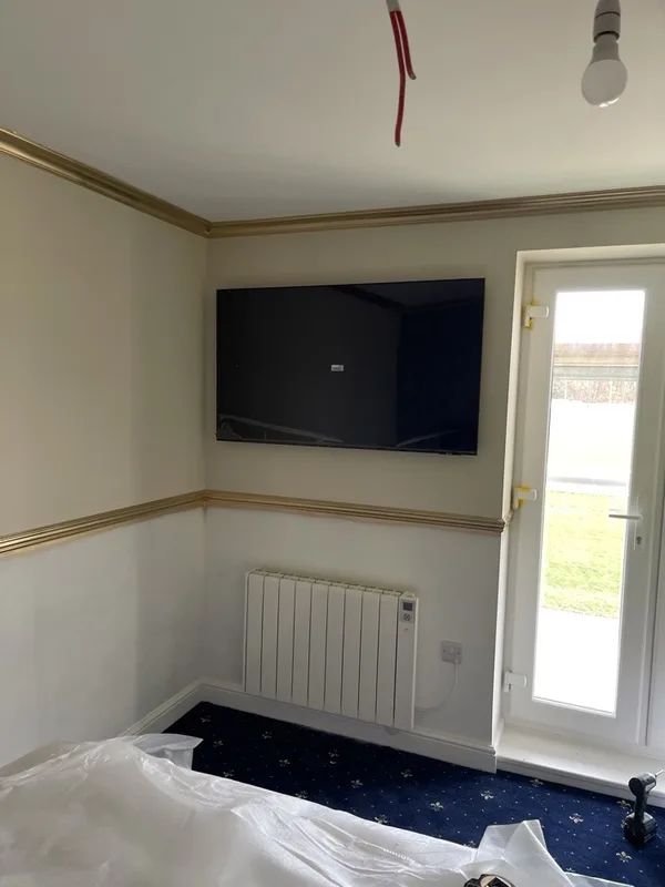 Wall-mounted TV in a hotel guest room