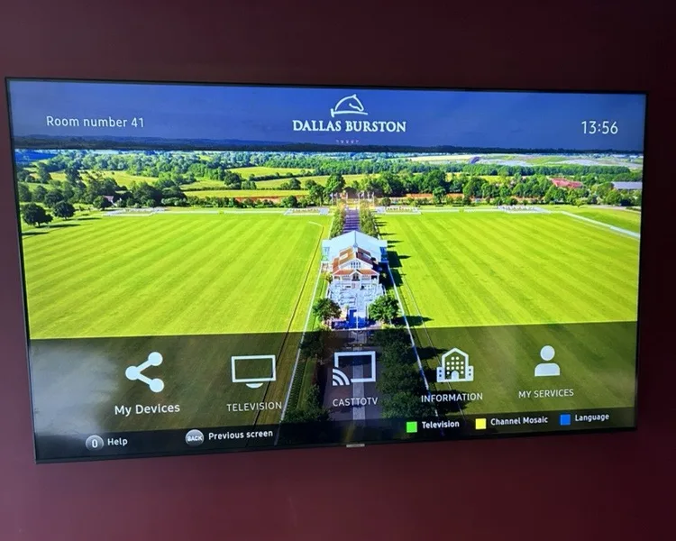 Guest-room TV showing the Dallas Burston welcome screen