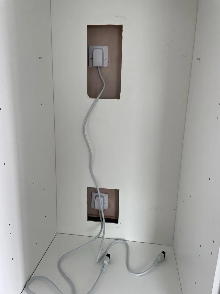 Cooker and appliance outlets fitted inside a kitchen housing unit