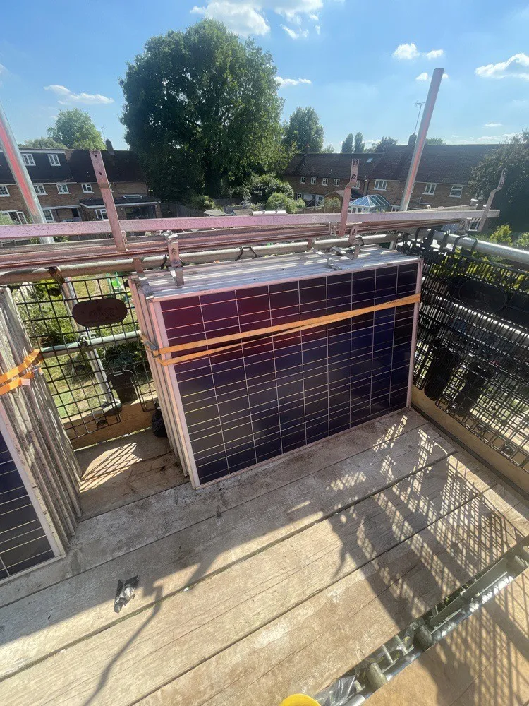 Removed solar panels strapped to the scaffold during re-roofing