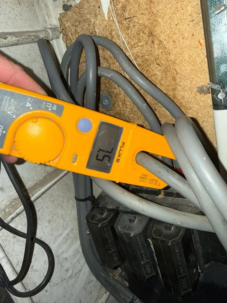 Clamp meter showing 7.5 amps on one phase of a three-phase supply
