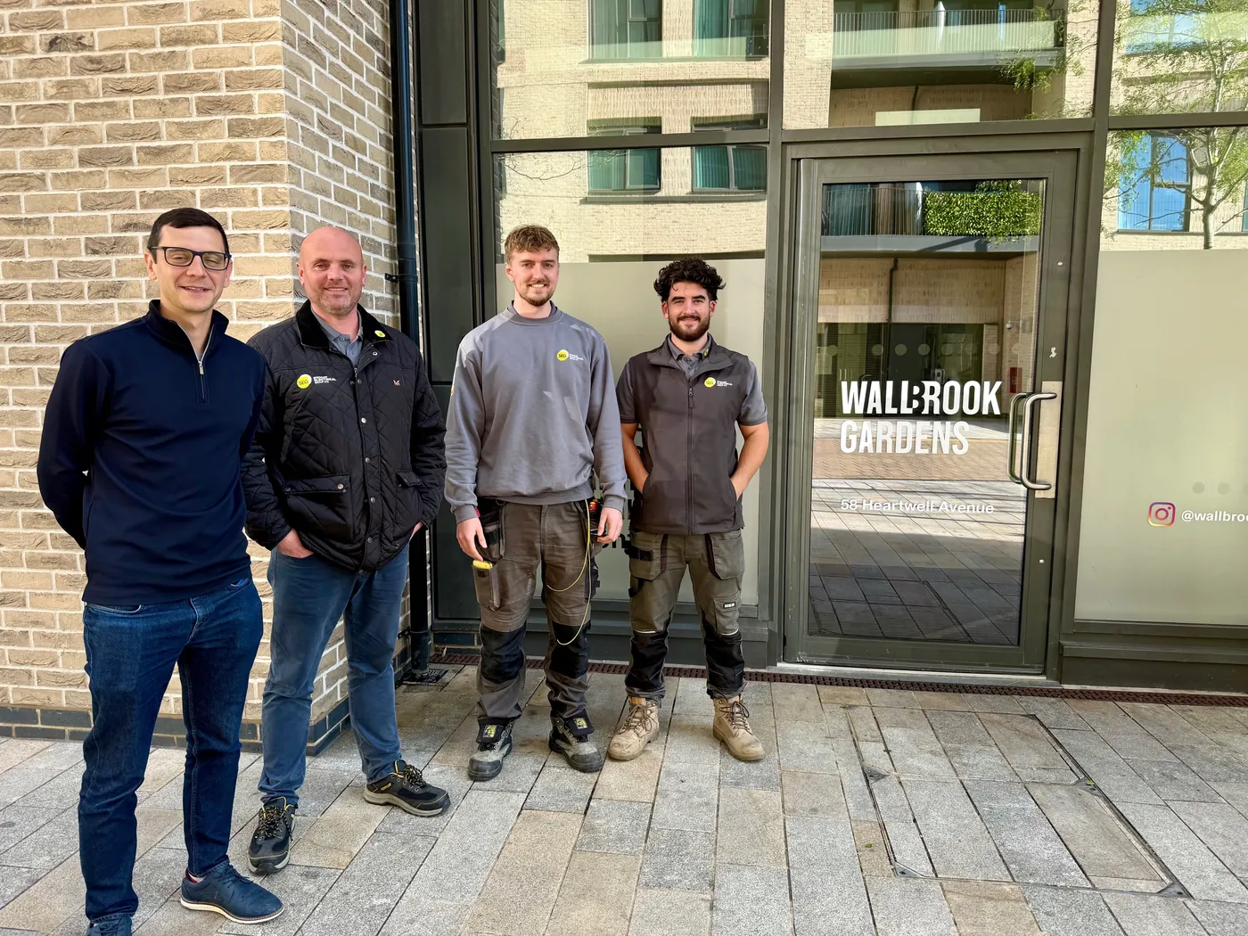 The SEG team outside the entrance to Wallbrook Gardens, Canning Town: Matthew, our Senior Contracts Manager, with engineers Luke and Oliver