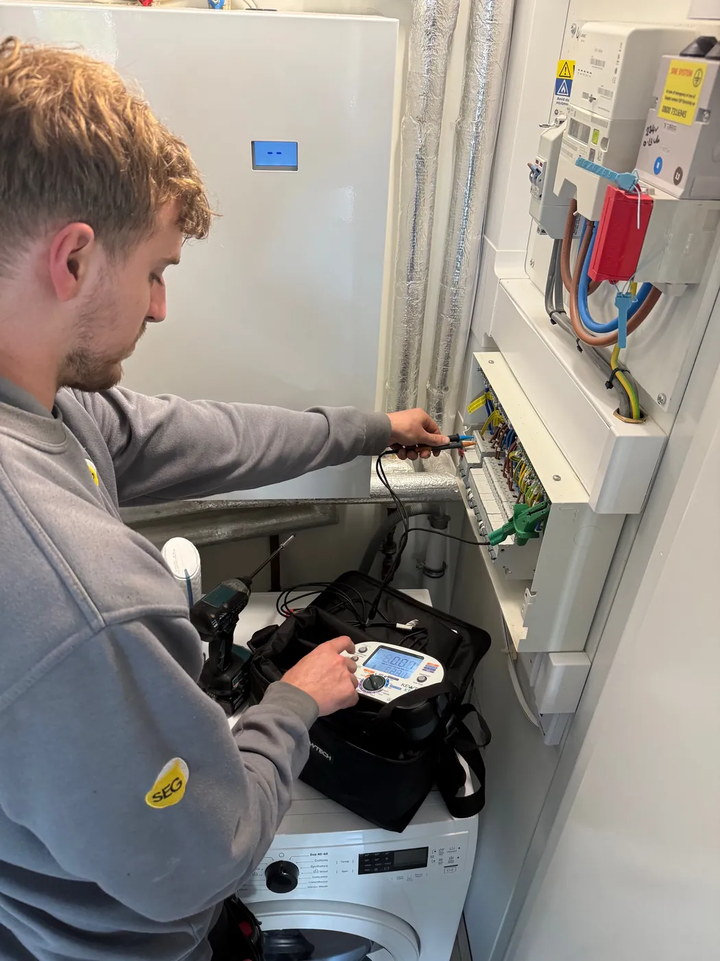 SEG engineer testing a consumer unit