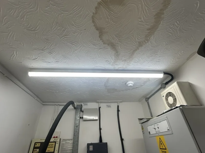 New LED batten light fitted under the water-stained ceiling