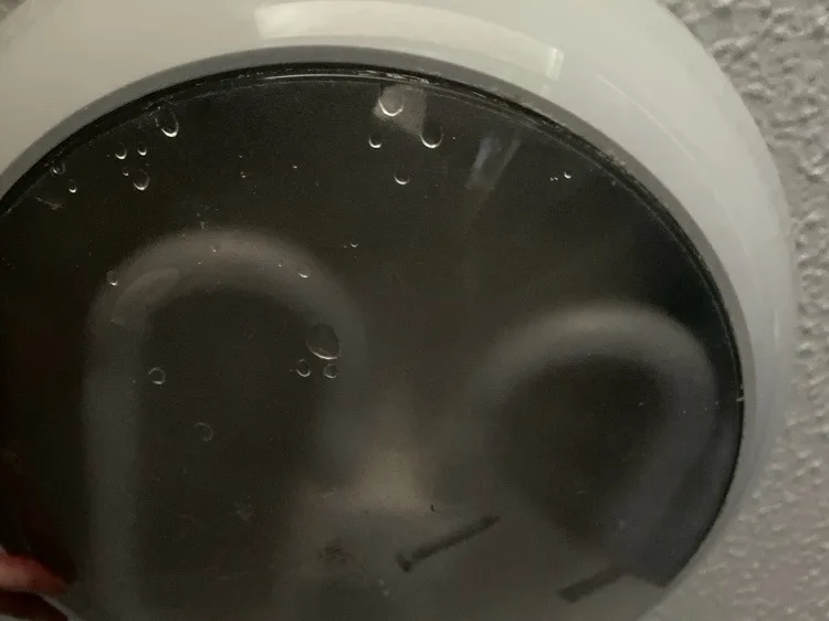 Water collected inside a ceiling light after a leak