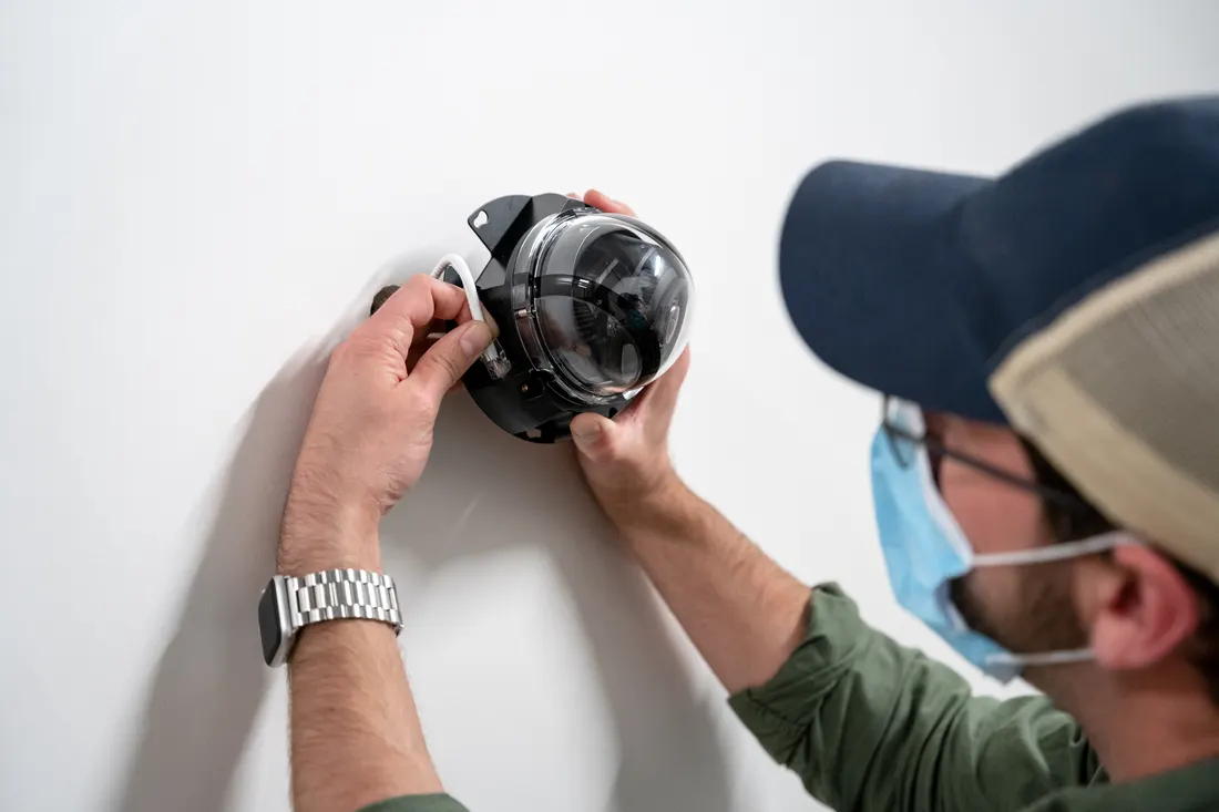 Engineer fitting a Verkada dome camera