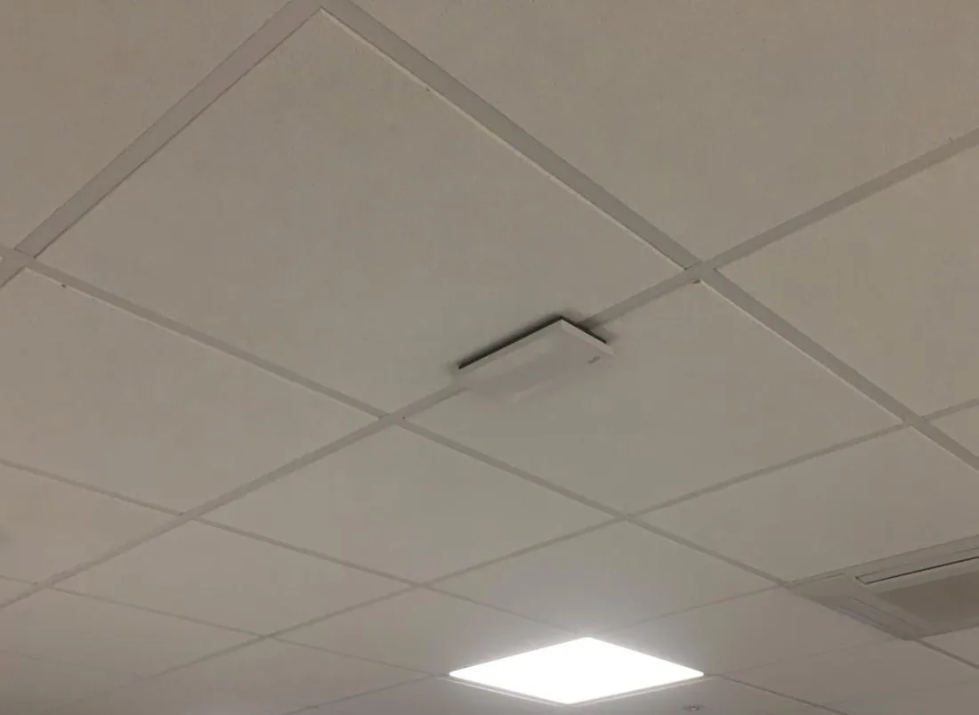 Neat ceiling-mounted Wi-Fi access point in an office